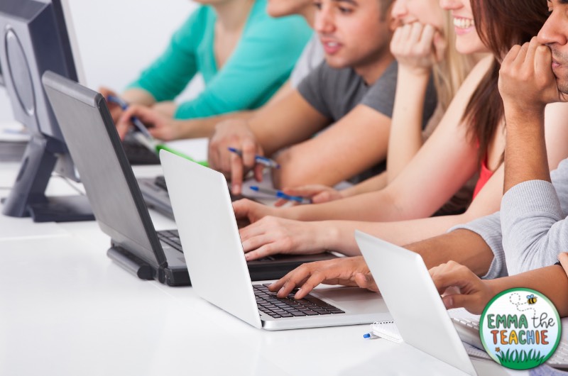 A group of high school students working on laptops