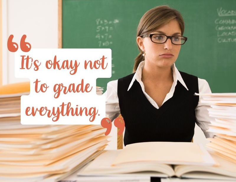A teacher is sitting at her desk with stacks of papers in front of her. She is blowing air out of her mouth, looking mildly stressed. Text shares a tip for new teachers to manage workload. It says, "It's okay not to grade everything".